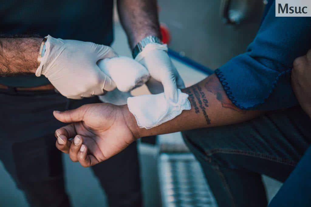 Person With White Bandage on Left Hand