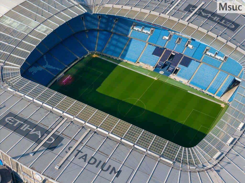 Stunning aerial shot capturing the modern architecture of Etihad Stadium in Manchester.