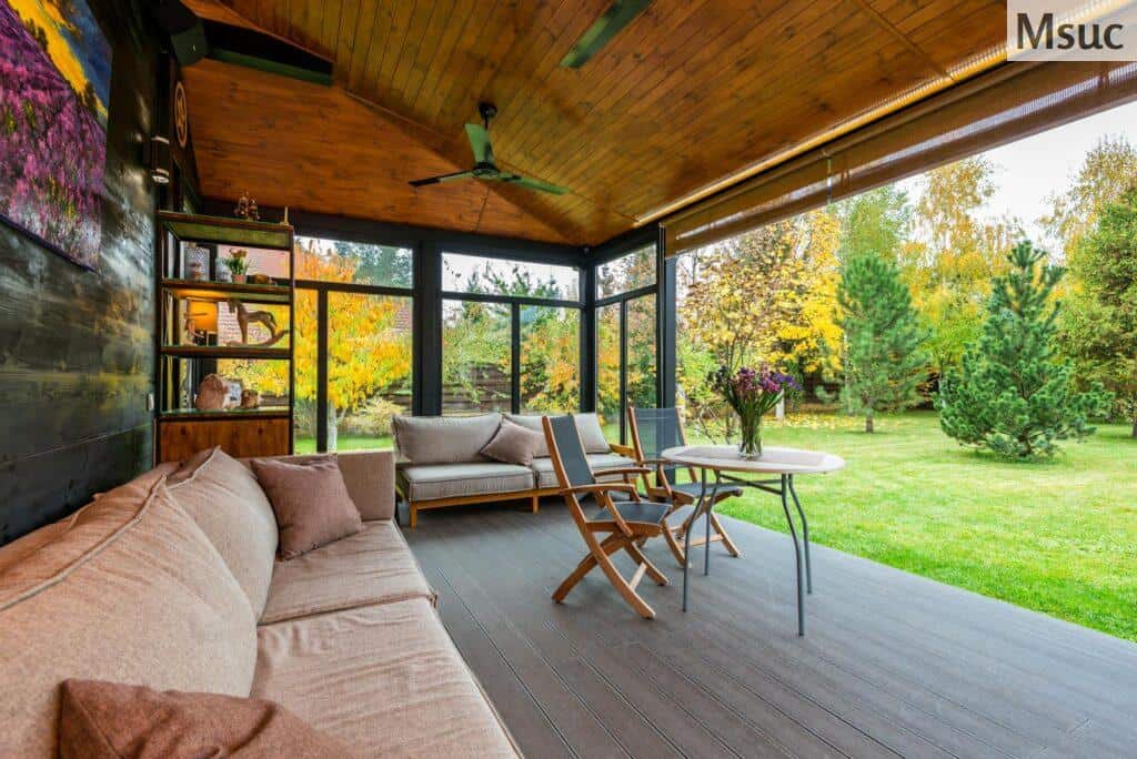 Elegant modern porch with comfortable seating and vibrant garden view.